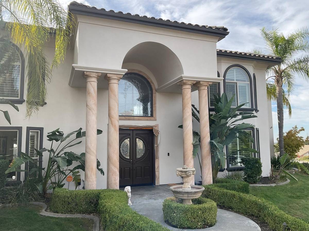 Front entry of a home mid-project with the door and trim carefully masked
