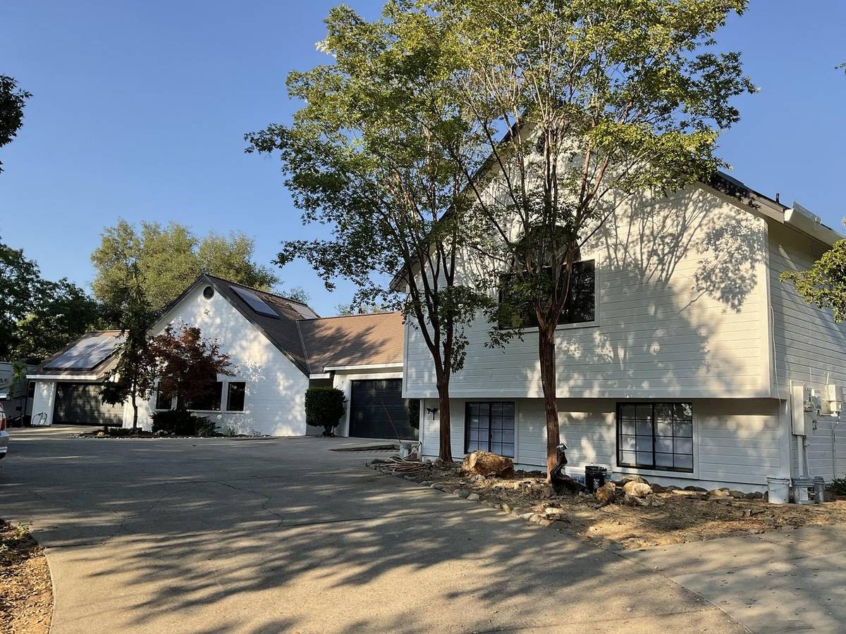 After: the same home finished in white with black windows