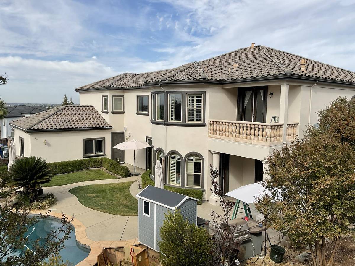 Large two-story home painted white with dark trim