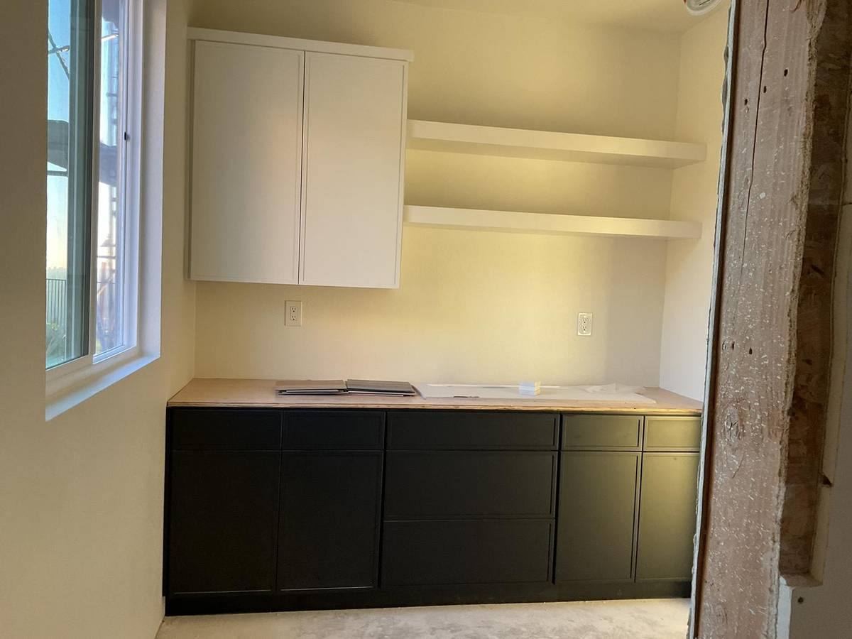 Freshly painted interior with white cabinets and black lower cabinets